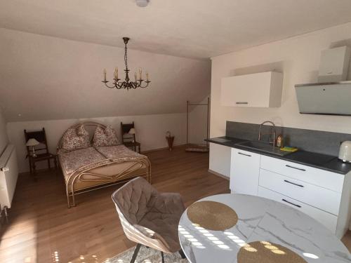 a kitchen and living room with a table and a couch at Ferienwohnung Salzwiese in Brodenbach