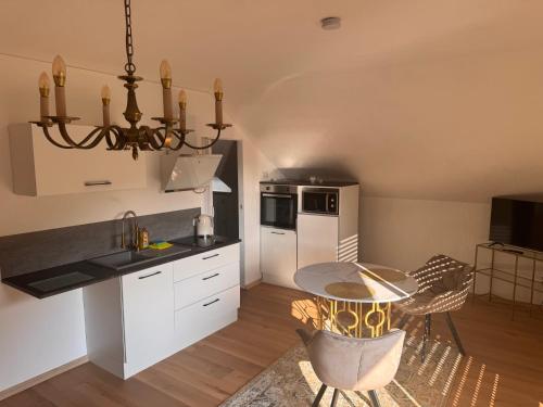 a kitchen with a table and a dining room at Ferienwohnung Salzwiese in Brodenbach