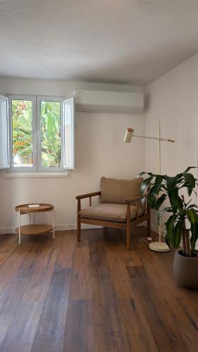 a living room with a couch and a potted plant at Refúgio das Marés in Ponta Delgada