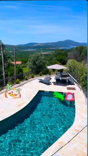 a swimming pool in a backyard with a swimming poolvisor at PoolSide Residence in Kavač