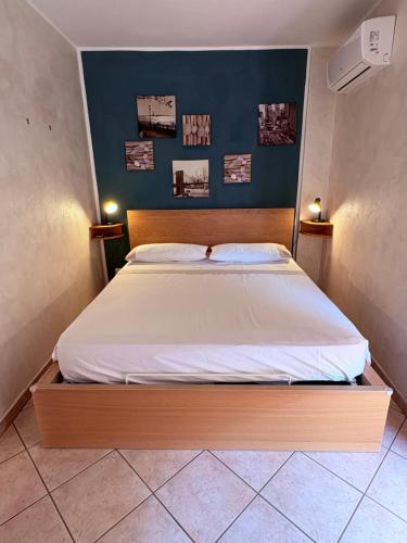 a bedroom with a bed with a blue wall at La Terrazza in Civitavecchia