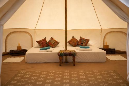 a bedroom with two beds in a tent at CALMA TIPI Glamping con piscina en Chiclana in Chiclana de la Frontera
