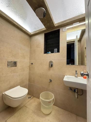 a bathroom with a toilet and a sink at Cinnamon Villa - The Dream Stays ll Pvt Pool ll 3Ac Rooms ll Wi-Fi in Khandāla