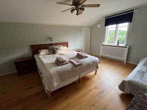a bedroom with a bed with two towels on it at Per Larsgård in Veddige