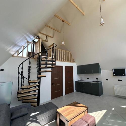 a living room with a spiral staircase in a loft at Casa Verde&Mare in Sharabidzeebi