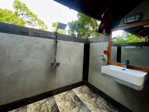 a bathroom with a sink and a mirror at Ama Villa - Habarana in Habarana