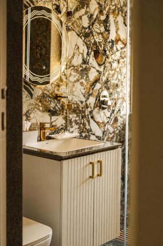 a bathroom with a white sink and a mirror at Vale Montis Near Dal Lake Srinagar in Srinagar