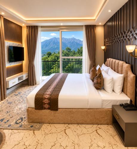 a bedroom with a large bed and a large window at Vale Montis Near Dal Lake Srinagar in Srinagar