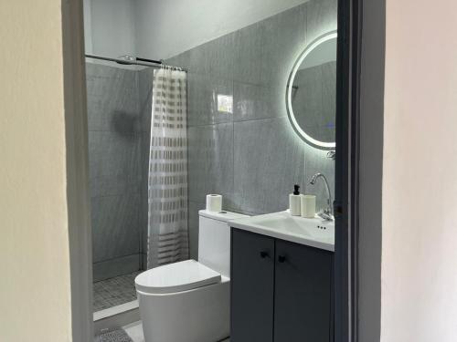 a bathroom with a toilet and a sink and a shower at Monarca Village in La Libertad