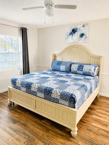 a bedroom with a bed with a blue and white comforter at Cozy Tampa Home in Tampa