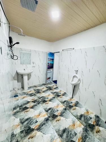 a bathroom with a sink and a toilet at Glowhaven Hostel in Sigiriya