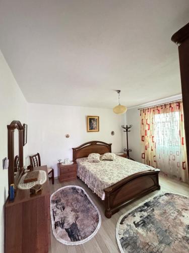a bedroom with a bed and a table and a rug at The Grandparent's House in Piskupat
