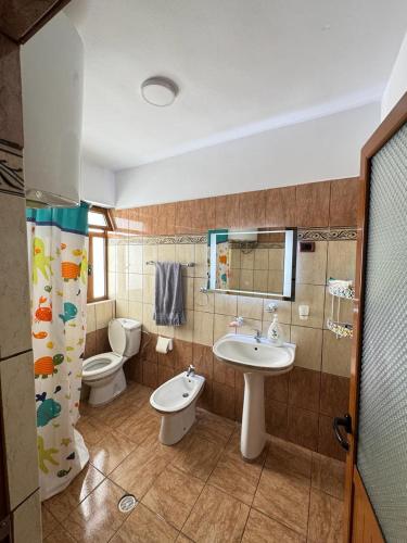a bathroom with a sink and a toilet and a sink at The Grandparent's House in Piskupat