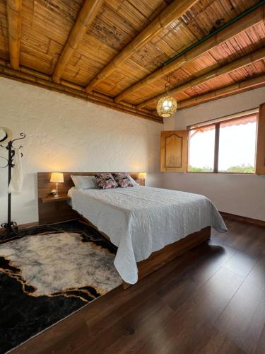 a bedroom with a bed and a wooden ceiling at Villa Mara in Filandia