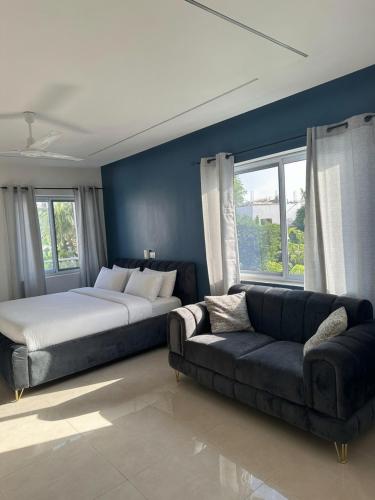 a bedroom with a bed and a couch at The Hills in Accra