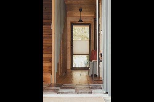 a hallway with a door leading into a house at gemütliches Holzhaus am See in Warin