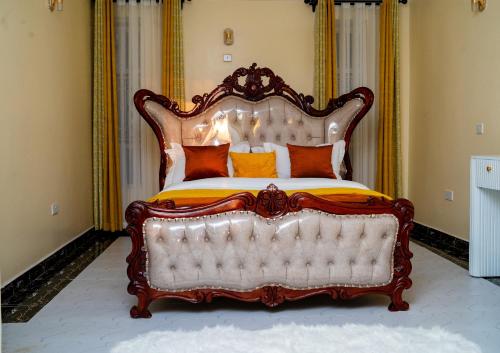 a large bed with an ornate headboard in a room at Godly Homes 5km frm Weiteithie! 4BR mdrn home in Ruiru
