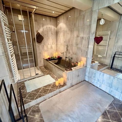 a large bathroom with a shower and a tub at Apartment WEITBLICK in Wald im Pinzgau