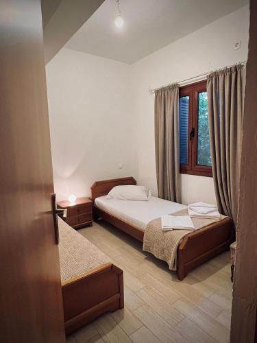 a bedroom with two beds and a window at Nancy in Politika