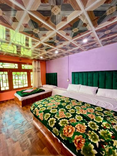 a bedroom with two beds in a room at Saleem Resort in Skardu