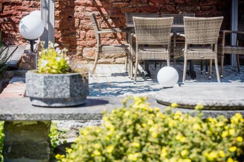 a patio with chairs and a table and flowers at Business Pension Gasper in Raunheim