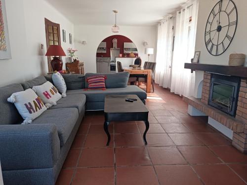 a living room with a couch and a fireplace at Mon Petit Château Grand appartement de 120 m2 in Pajay