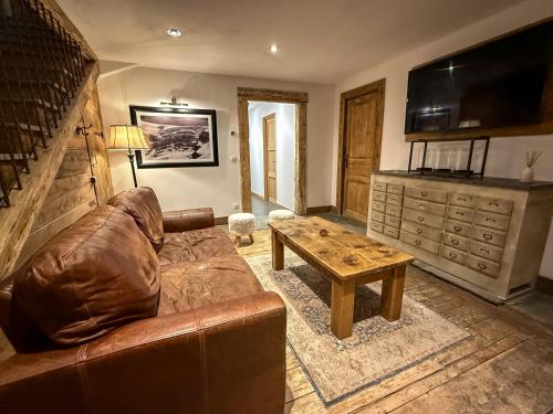 a living room with a couch and a coffee table at Black Diamond Sainte Foy Chalets in Sainte-Foy-Tarentaise