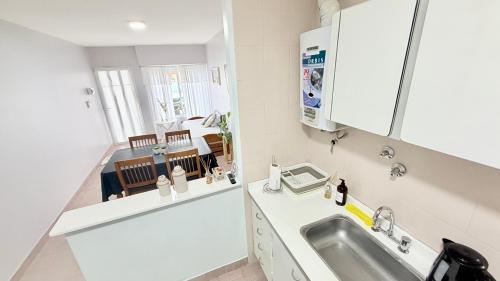 a small white kitchen with a sink and a counter at AltaMar in Playa Unión