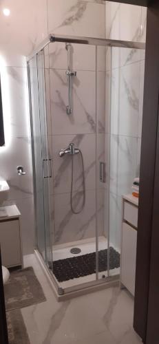 a shower with a glass door in a bathroom at Private small studio in Qrendi