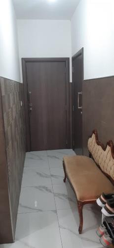 a room with a bench and a pair of doors at Private small studio in Qrendi