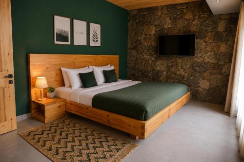 a bedroom with a large bed and a tv at Lavender Resort Naran in Naran