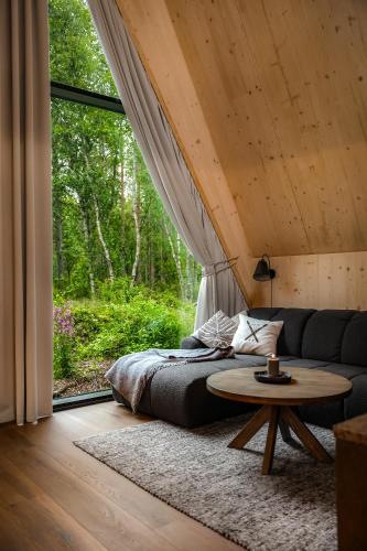 a living room with a bed and a table at Holmen Husky Lodge in Alta