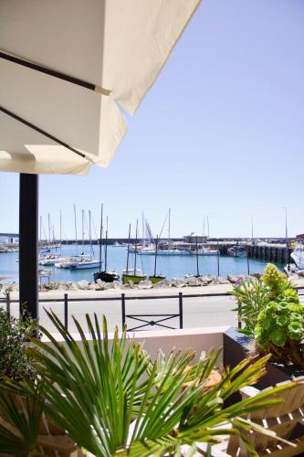 a view of a marina with boats in the water at Logis Hotel Du Port in Plobannalec-Lesconil