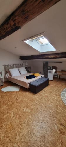 a bedroom with a large bed in a attic at Gite De Charme in Ganac
