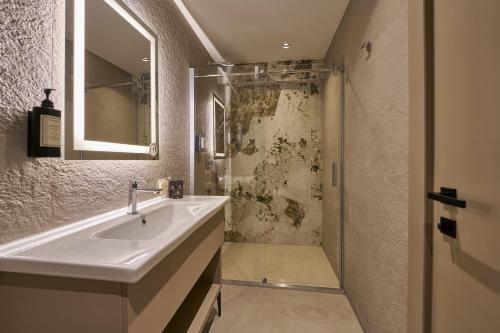 a bathroom with a sink and a shower at Ramses Hotel İzmir in İzmir