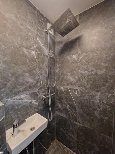 a bathroom with a sink and a shower at Moon Love in Pakopi