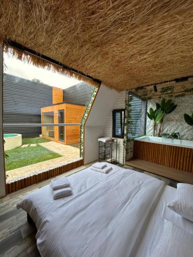a bedroom with a large bed and a large window at Dilijan House in Dilijan