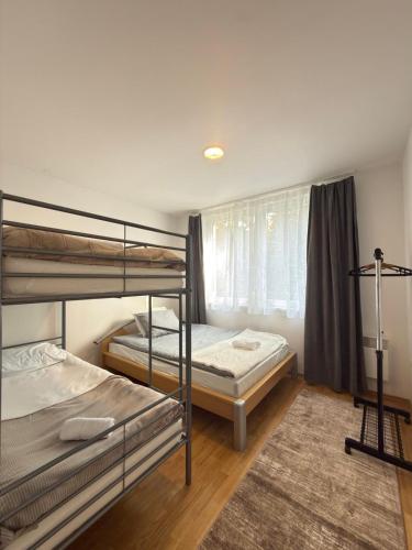 a bedroom with two bunk beds and a rug at Valverde Apartment Vlašić in Šišava