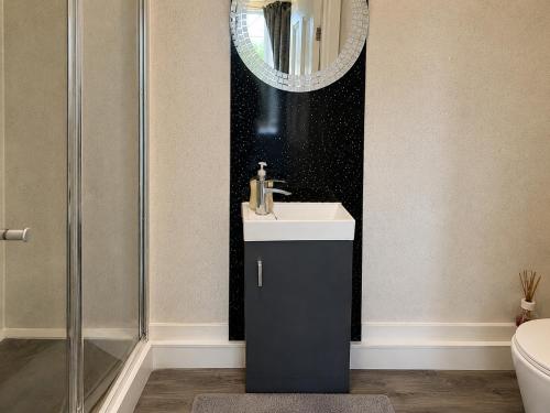a bathroom with a sink and a shower at 55 Studio 1 Uplands in Swansea