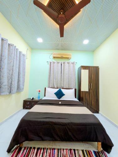 a bedroom with a large bed in a room at Indraprastha villa in Malavli