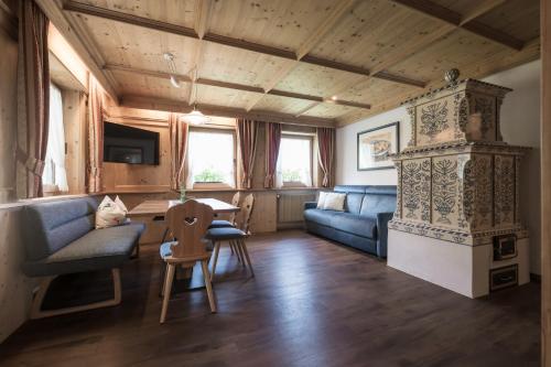a living room with a couch and a table at Chalet Aldian Dolomites in Selva di Val Gardena
