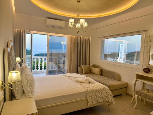 a bedroom with a bed and a couch and a window at Hotel Parga Princess in Parga