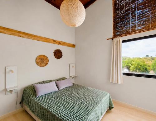 a bedroom with a bed and a window at Nao Tem Fim in Punta Del Diablo