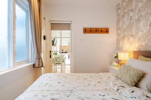 a bedroom with a large bed and a window at Lou-Lou in Zandvoort