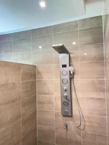 a shower with a control panel in a bathroom at Appartement Güstrow "free energy from solar Panels" in Lomé