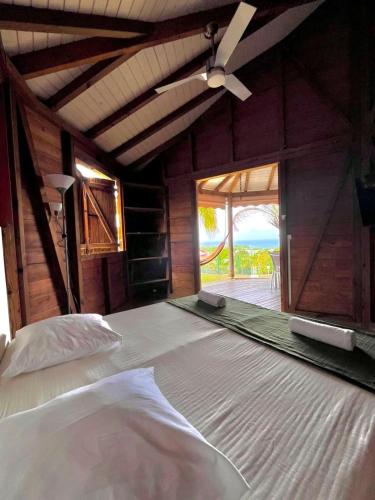 a bedroom with a bed and a ceiling fan at Baobab in Sainte-Anne