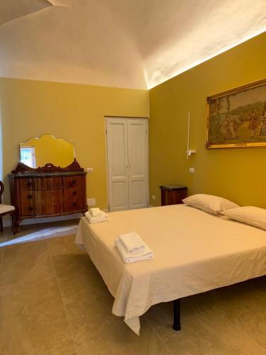 a bedroom with a large bed and a dresser at Palazzo TEDESCHI in Borgonovo Val Tidone