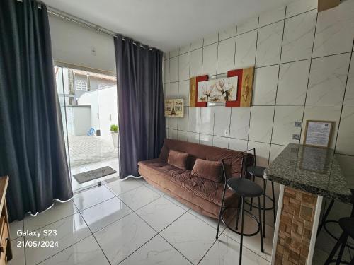 a living room with a couch and a table at Apart ZSS in Penha