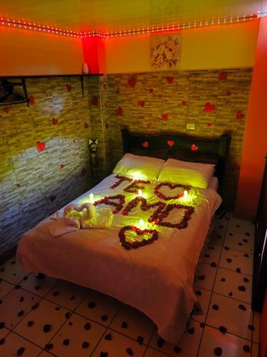 a bedroom with a bed with lights on it at Kenai Mountain View in Concepción