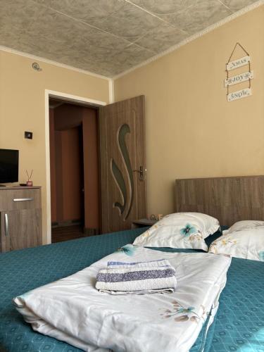 a bedroom with a bed with two pillows on it at Apartament Iulia in Orşova